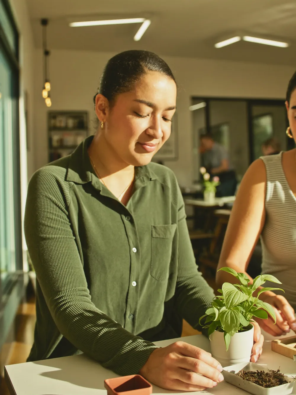 An adult guest and a support professional working together on a hands-on activity
